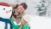 father and daughter with snowman